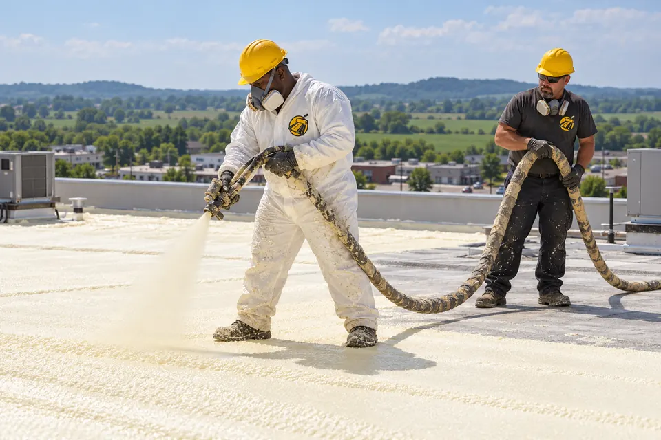 Crew spraying foam on a commercial roof